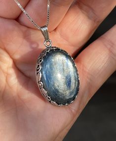 "Raw, natural, Kyanite gemstone pendant necklace, set in oxidized, 925 sterling silver crown floral bezel setting (open back), with 18\"  inches long chain. Pendant Included Bail: 1.40\" x 0.80\" inches. Stone: 25mm x 18mm, Oval. Stone weight: 7-grams, or 35-CTTW. Blue kyanite is a good luck stone, especially when it comes to wealth and career. Owning a blue kyanite and wearing it close to your body will fill you with the energies that will attract good luck to you!" Blue Stone Necklace, Natural Stones Necklace, Silver Crown, Gemstone Necklace Pendant, Fantasy Jewelry, Oxidized Sterling Silver, Silver Stars, Jewelry Inspo, Dream Jewelry