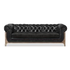 a black leather couch with wooden legs and buttons on the back, in front of a white background