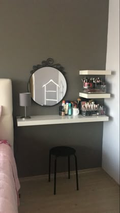 a bedroom with a bed, desk and mirror