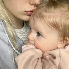 a woman holding a baby in her arms