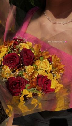 a woman holding a bouquet of flowers in her hands