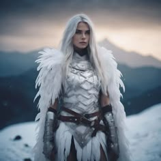 a woman with white hair and wings standing on top of a snow covered hill in front of mountains