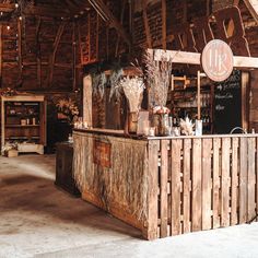 an old fashioned bar is set up in a barn