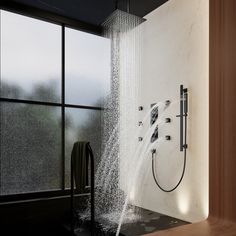 a shower head with water coming out of it in a bathroom next to a window