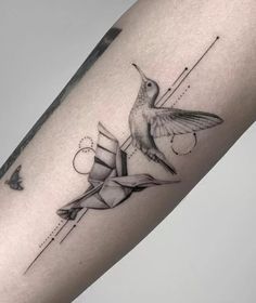 a hummingbird tattoo on the right arm and leg, with geometric shapes around it