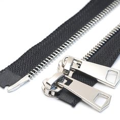 two metal zippers are attached to the side of a black belt with an open end