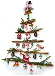 a christmas tree with ornaments hanging from it's branches and decorations on the top