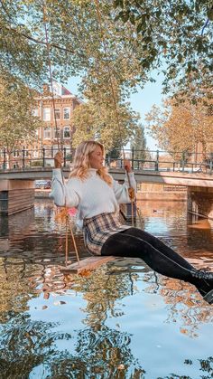 a woman sitting on top of a boat in the water