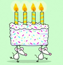 two mice carrying a birthday cake with lit candles on it and the words happy birthday