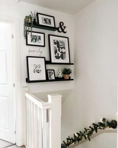 the stairs are decorated with pictures and garland