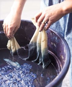 a person holding some food in a bucket