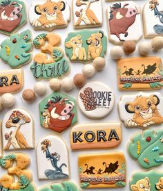 the lion king cookies are decorated with royal icing and fondant, along with other disney characters