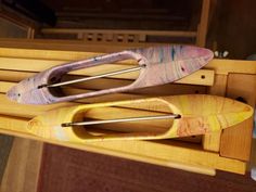 two wooden paddles sitting on top of a table