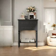 a living room with a couch, table and flowers on top of the end table