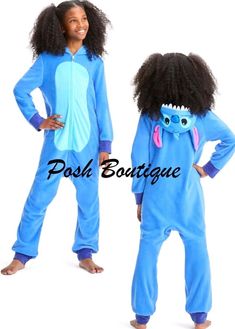 two children in blue onesuits standing next to each other with one child's face on it