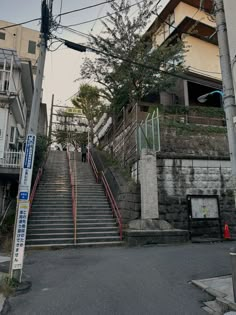 a set of stairs leading up to the top of a hill in an urban area