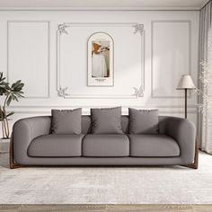 a living room with a gray couch and white walls