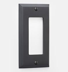 an image of a light switch cover on a white wall with black trim and metal accents