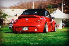 a red sports car parked in the grass