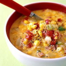 a bowl of soup with corn and tomatoes