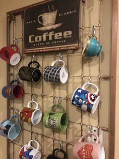 coffee mugs are hanging on a metal rack