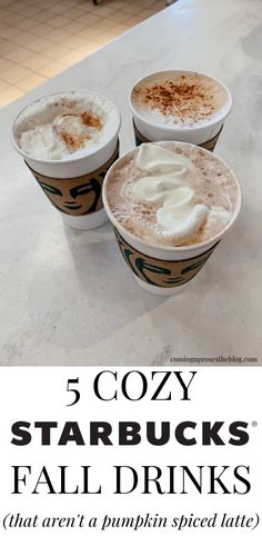 three cups of coffee with whipped cream on top and the words 5 cozy starbuckss fall drinks that aren't pumpkin spice latte