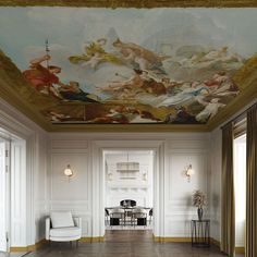 the ceiling in this room is decorated with paintings