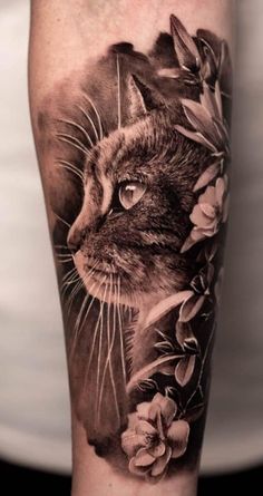 a cat with flowers on it's arm and the image is done in black and white