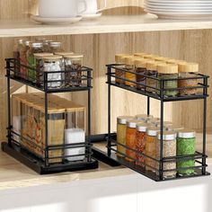 two black spice racks with spices and seasonings in them