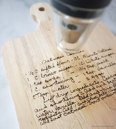 a wooden cutting board with writing on it