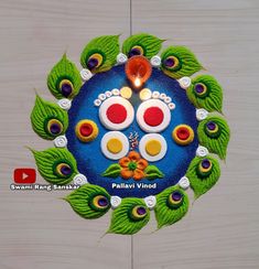 an intricately decorated diya with peacocks and leaves