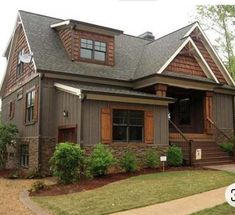 a house that is made out of wood and has brown shingles on the roof