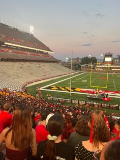 a football stadium filled with people sitting on the bleachers