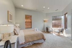 a bedroom with white walls and carpeted flooring