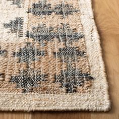 a close up of a rug on a wooden floor with a wood flooring surface