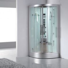 a corner shower in a white room with a rug on the floor