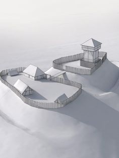 an aerial view of a snow covered hill with two small buildings on it's sides