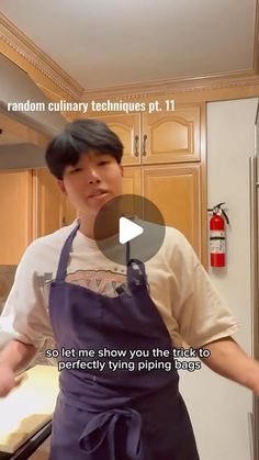 a man wearing an apron standing in front of a refrigerator