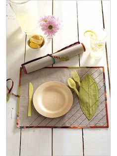 a place mat with utensils and napkins on it