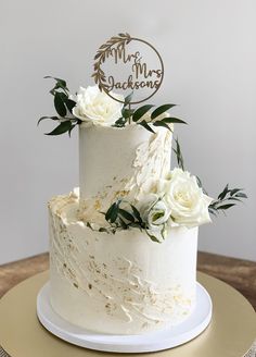 a wedding cake with white flowers on top