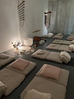 a room filled with lots of pillows on the floor