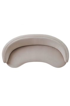 an oval shaped couch sitting on top of a white floor