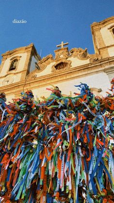 colorful ribbons are tied to the side of a building