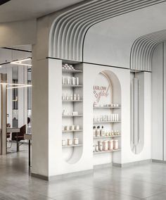 the inside of a store with shelves filled with bottles and jars on display in front of mirrors