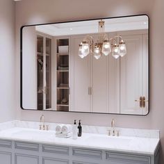 a bathroom vanity with a large mirror above it