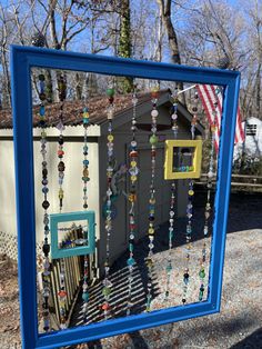 a blue frame with beads hanging from it