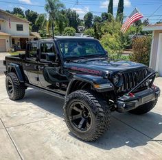 a black jeep parked in front of a house