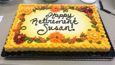 a yellow and black birthday cake with the words happy retirement susan on it's side