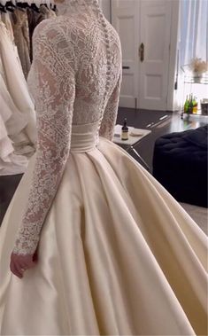 a woman in a wedding dress looking at her reflection