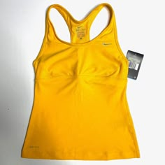 Nike Dri-Fit Training Top. Sleeveless. Perfect For High Impact Sports. Ventilated. Stay Cool Technology. Size: Xs Condition: New With Tags Measurements: Length 21” | Armpit To Armpit 12 ¾” | Shoulder To Shoulder 9” | *Measurements Are Approximate & Taken With Item Laying Flat* Sporty Fits, Diy Outfits, Tennis Tank Tops, Cute Clothing Stores, Tennis Shop, Y2k Wallpaper, Yellow Tank Top, Clothing Pieces, Casual Preppy Outfits